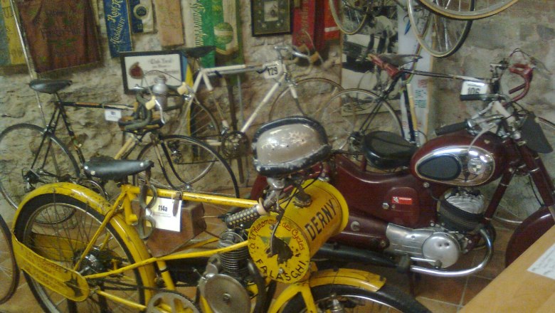 Old bicycles and motorcycles at the Vösendorf Castle Bicycle Museum.