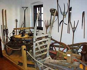 Exhibition of agricultural equipment in a museum.