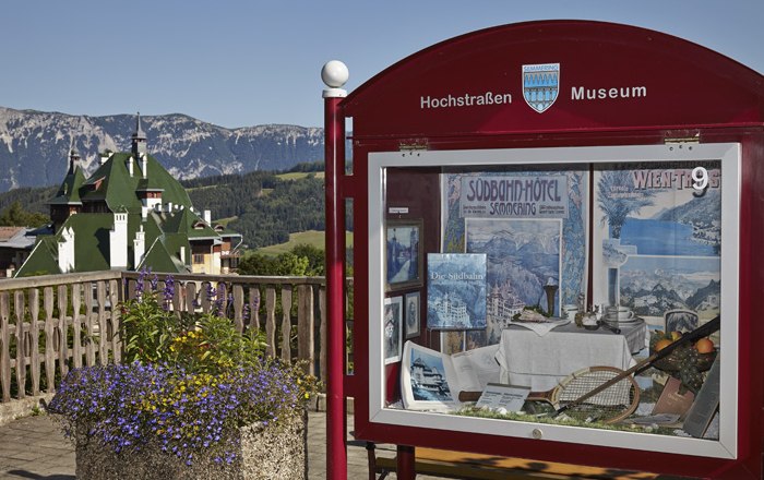 Showcase of the High Road Museum with mountain landscape in the background.