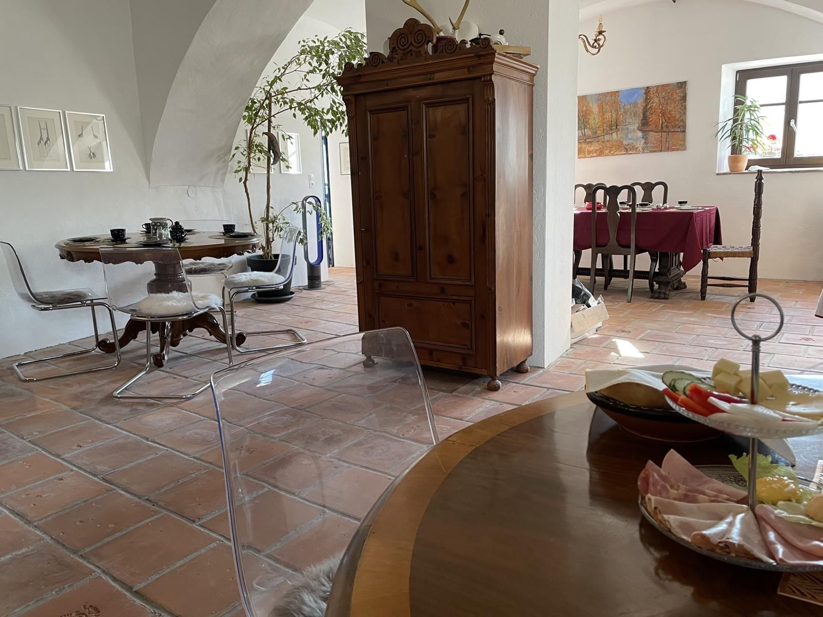 Interior view of a cozy room with wooden furniture, dining table and decorations.