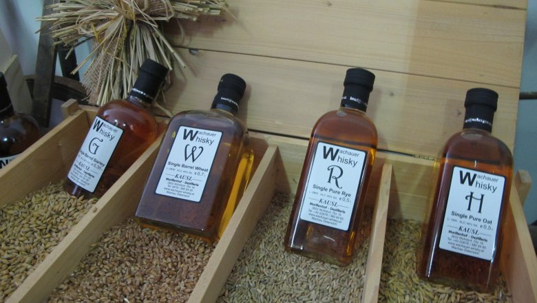 Bottles of Wachau whisky displayed on cereal grains.
