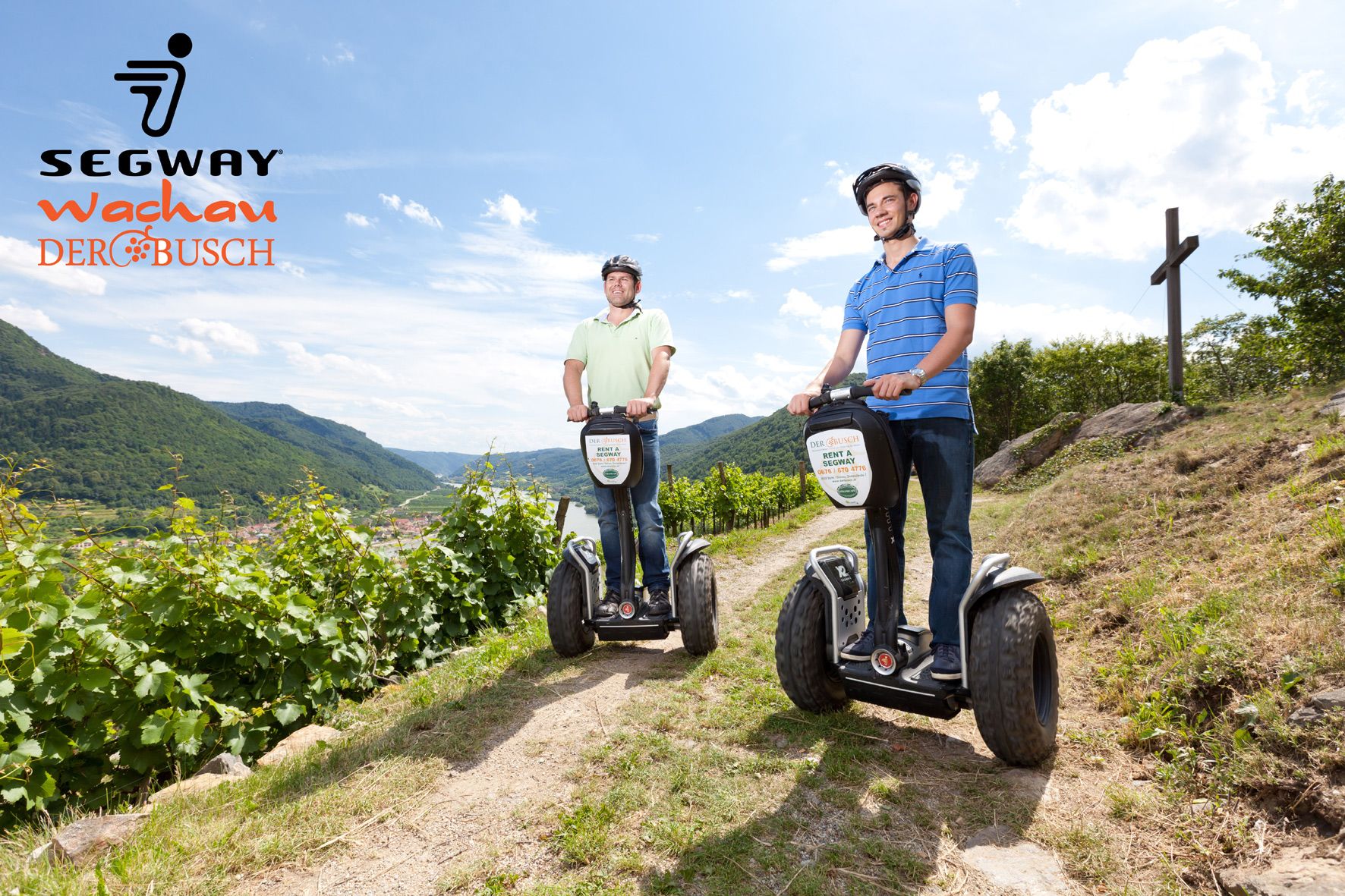 Two men ride Segways through a vineyard landscape in the Wachau.