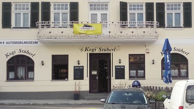 Facade of a restaurant called Kogi St&uuml;berl with balcony and closed shutters.