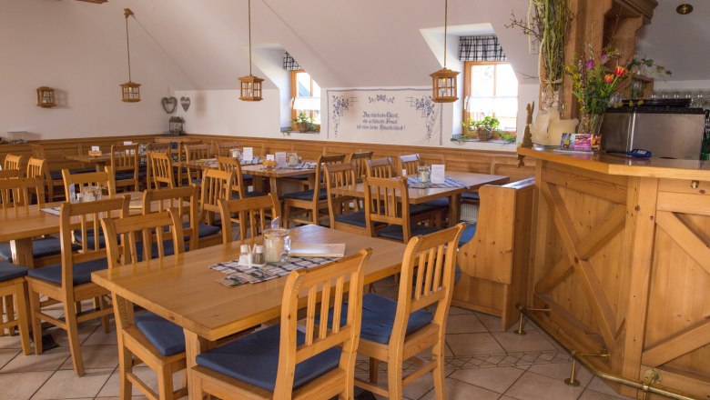 Interior view of a cozy dining room with wooden furniture and decorations.