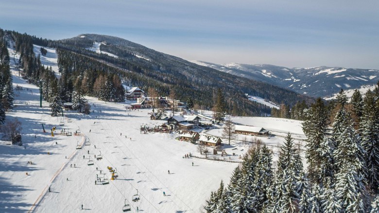 Winter landscape with ski lift and snow-covered mountains in Mönichkirchen.