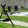Garden with swing, sun loungers and pool.