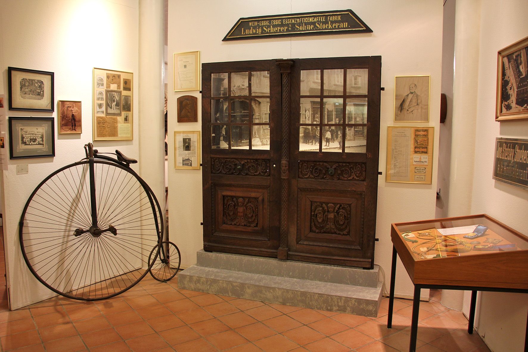 Interior view of the Stockerau District Museum with penny-farthing and historical exhibits.