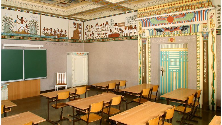 Egyptian-style classroom with murals and decorative door frame.