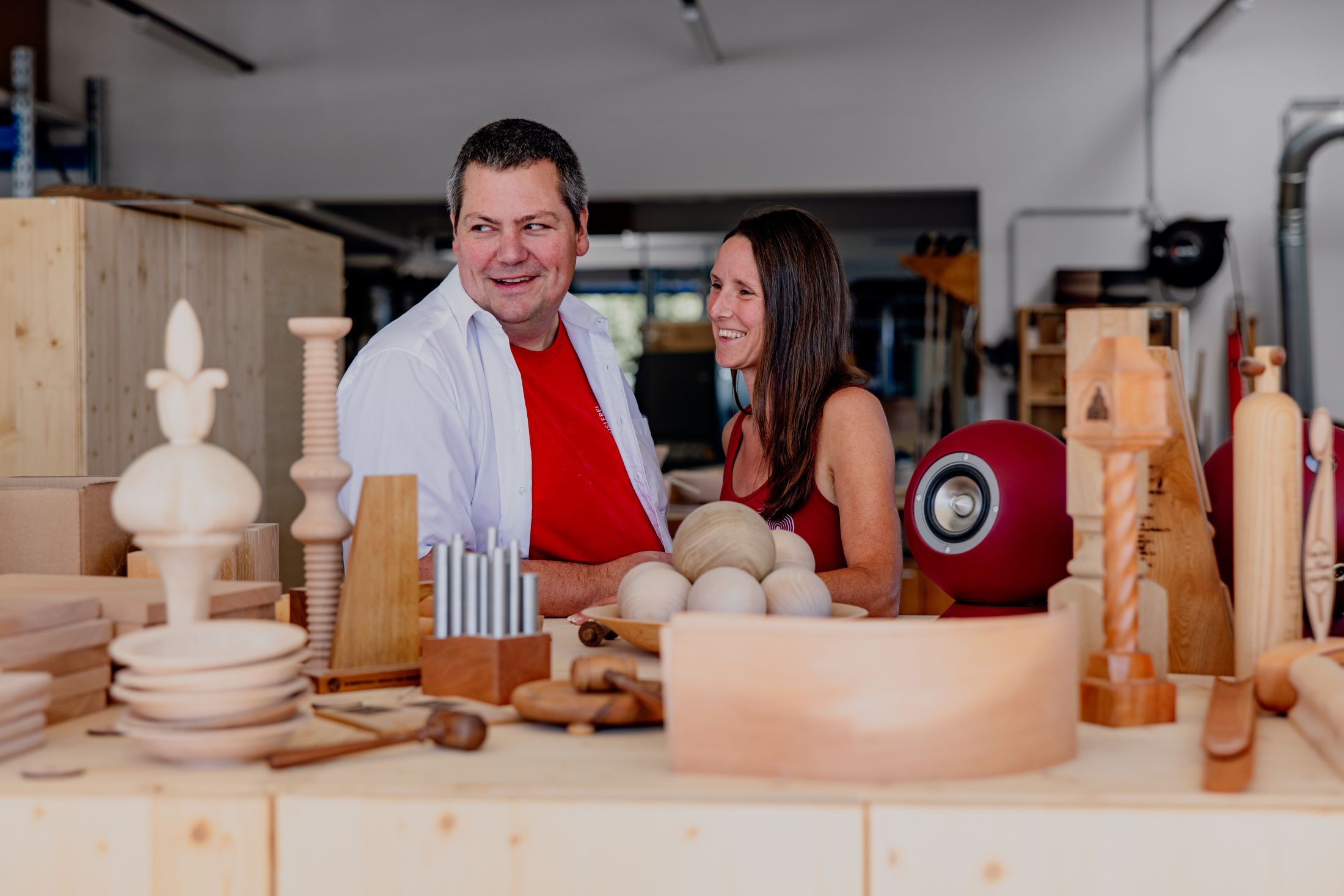Two people in a workshop doing woodwork.