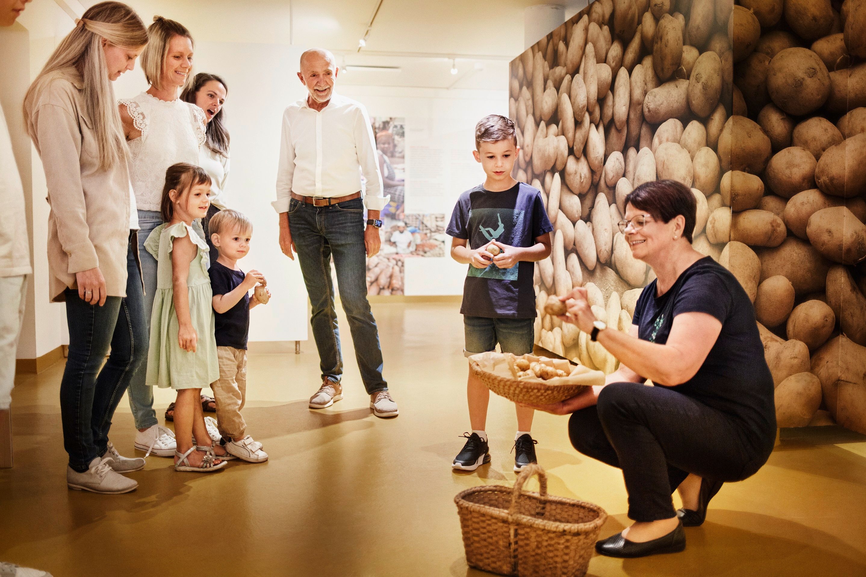 Group of people in a museum with a potato theme.