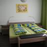 Guest room with double bed, colorful bedding and mural.