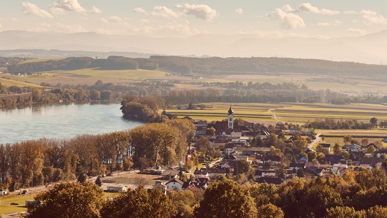 Landscape view of Gottsdorf in the Nibelungengau with river and church.