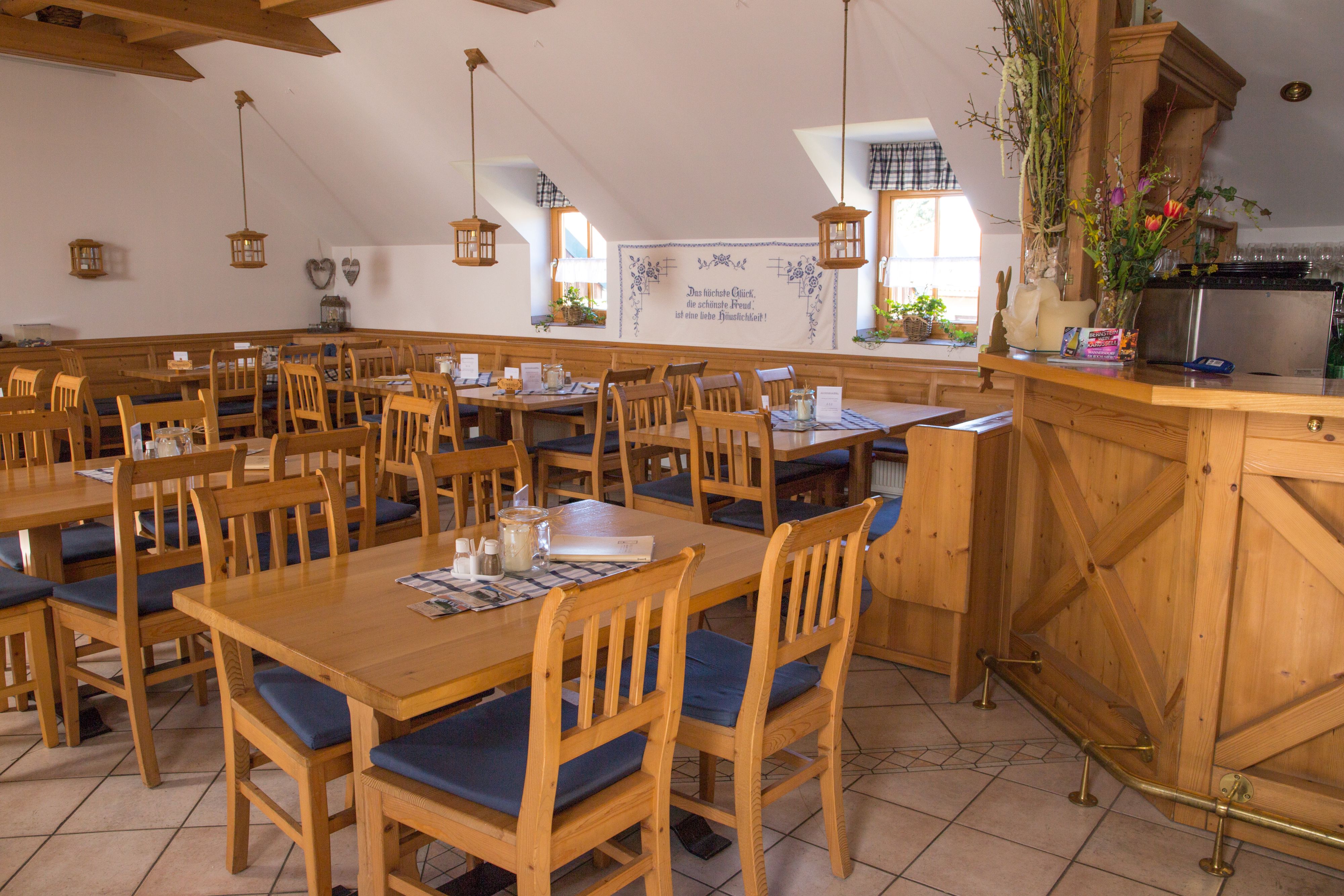 Interior view of a cozy dining room with wooden furniture and decorations.