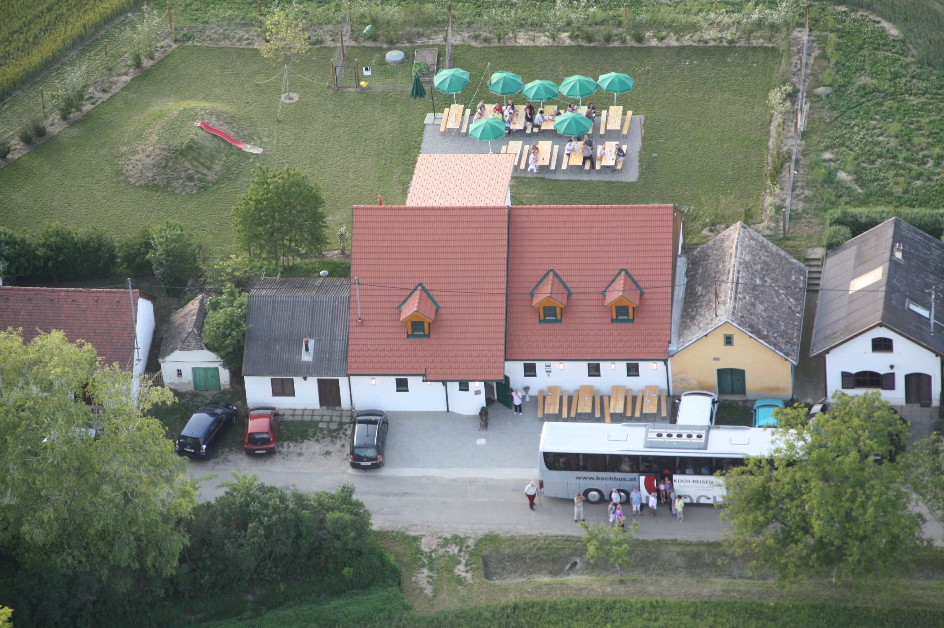 Aerial view of a winery with terrace and bus.