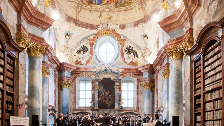 Concert in the baroque library of Altenburg Abbey with orchestra and choir.