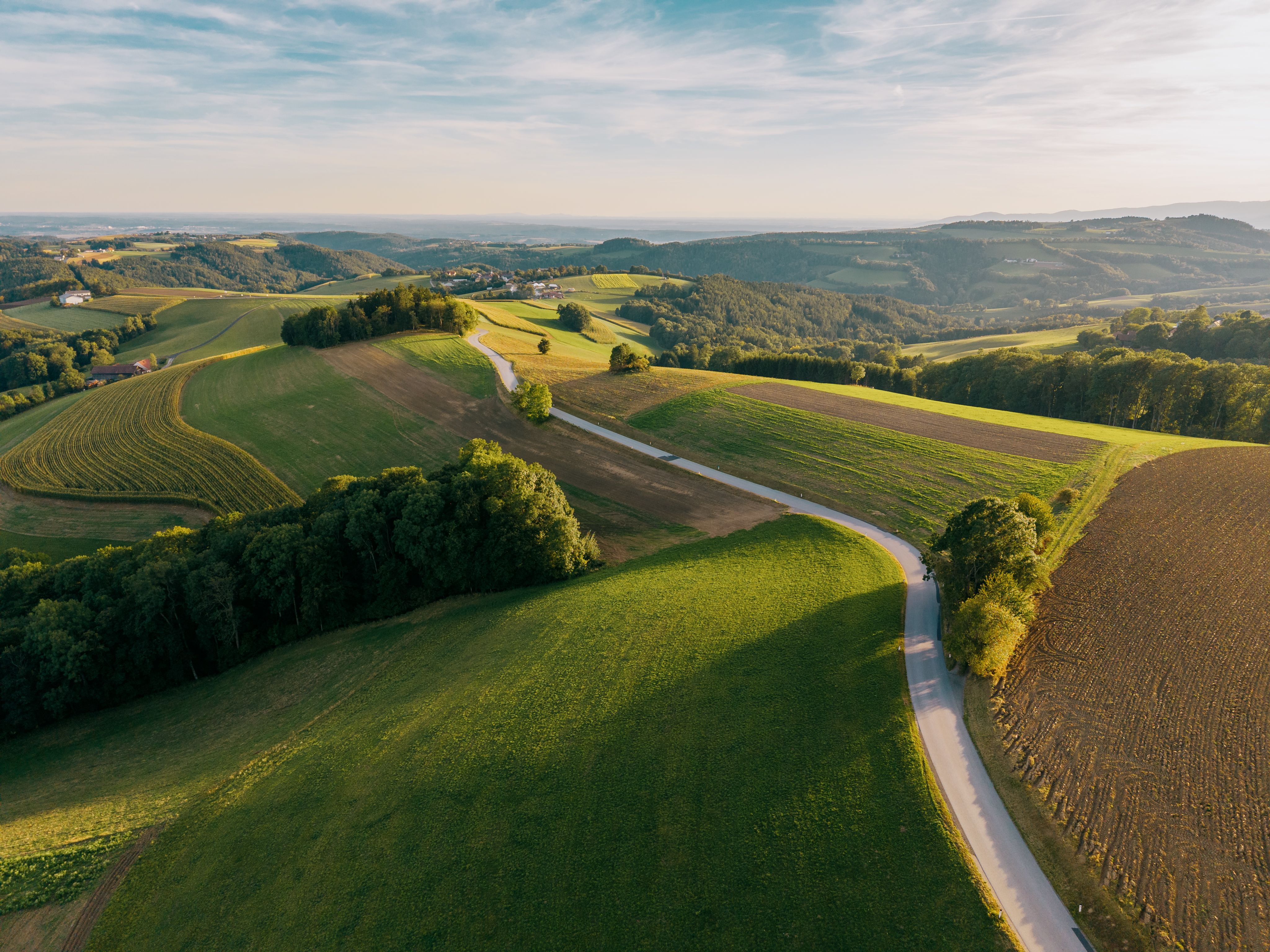 Aerial view of a hilly landscape with fields and forests in Hattmannsdorf, Hochneukirchen.