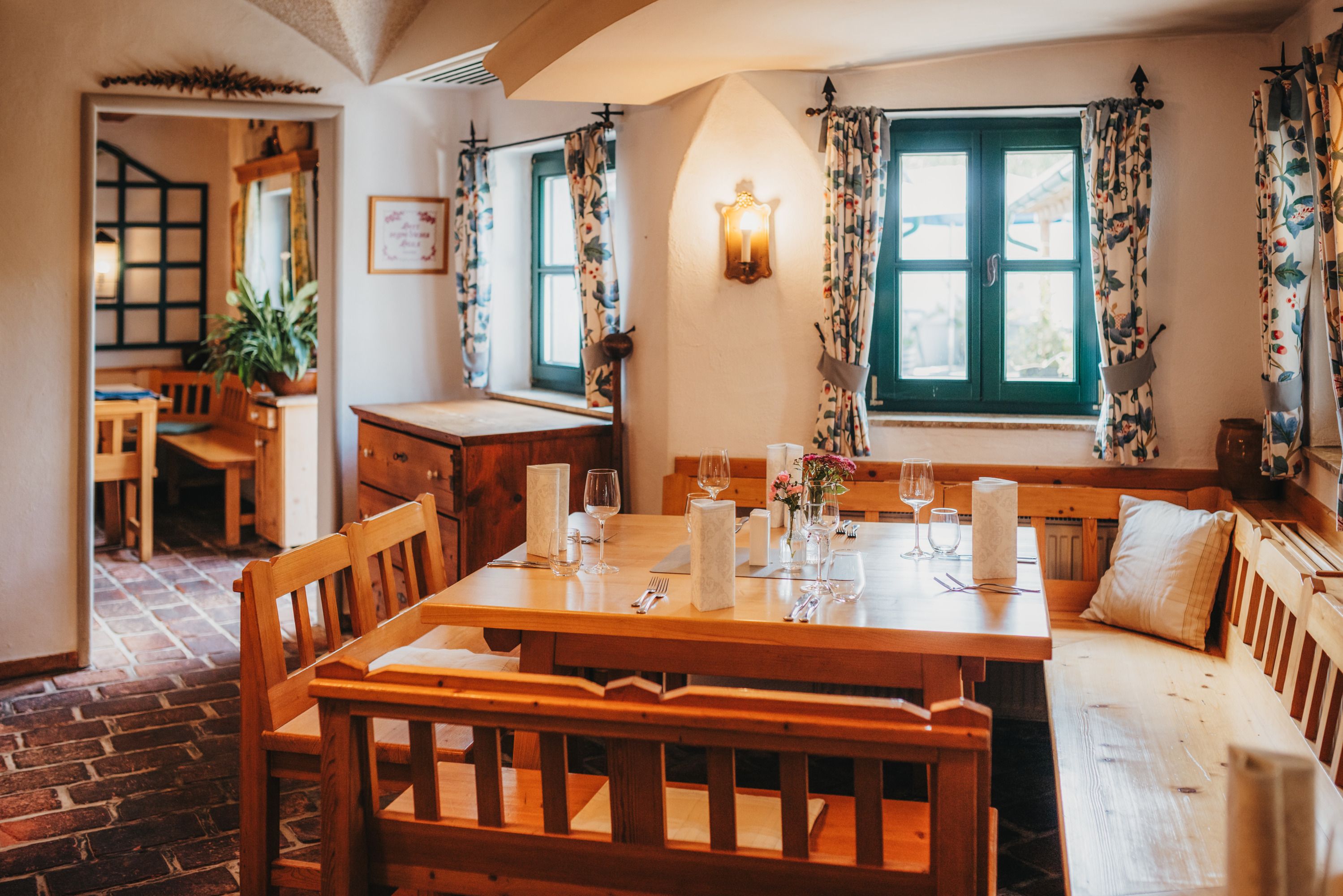 Cozy dining room with wooden furniture and table setting.