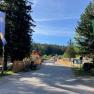 Entrance to the nature park center with flags and trees.