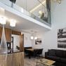 Modern apartment with gallery, wooden furniture and stylish lighting.