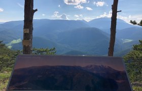 Gösing vantage point with a plaque and view of wooded mountains