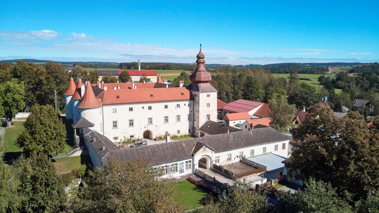 Aerial view of Dobersberg Castle with red roof and surrounding landscape.