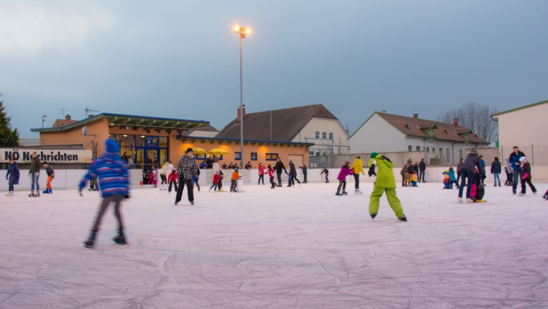 People ice skating on an artificial ice rink in Hollabrunn.
