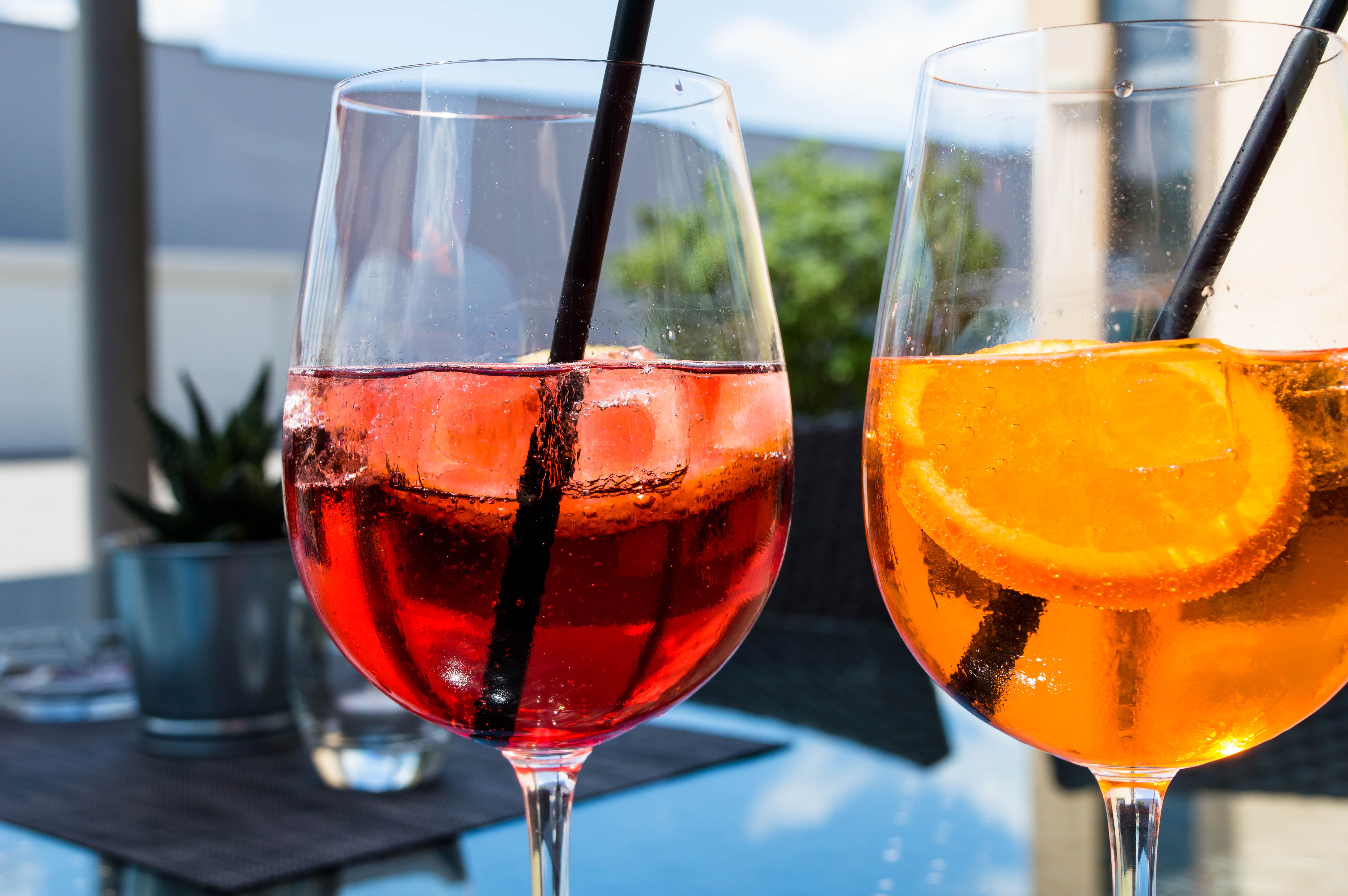 Wine glasses filled with red and yellow drink 