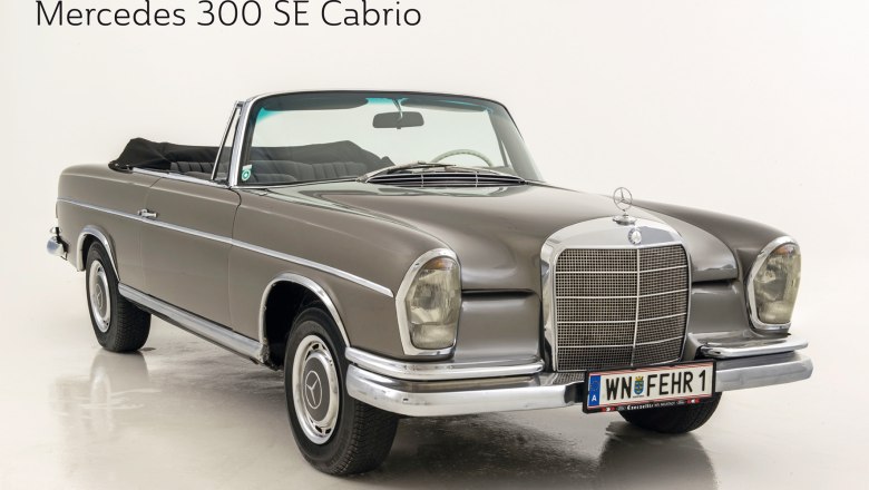 A gray Mercedes 300 SE convertible with an open top on a white background.