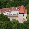 Aerial view of Ulmerfeld Castle, surrounded by trees.