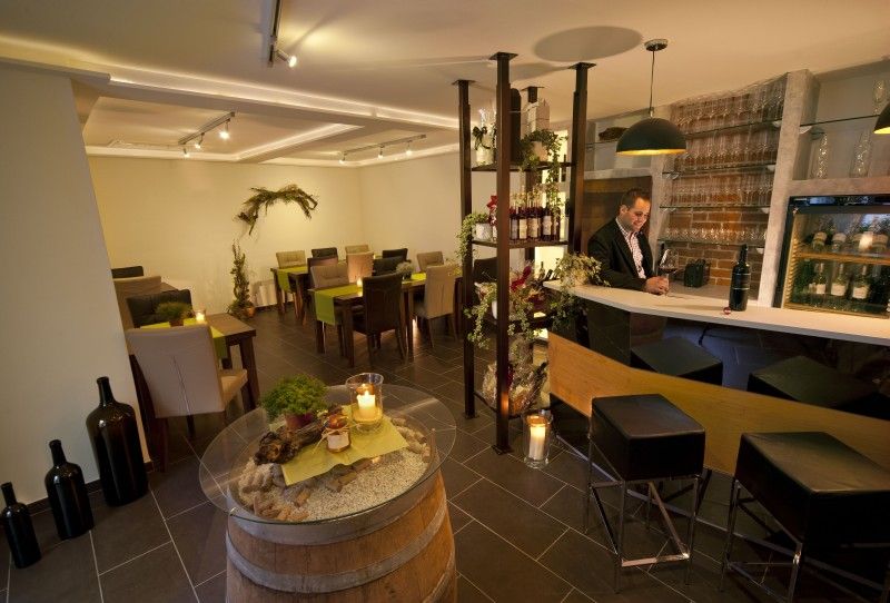 A stylish tasting room with bar, tables and decoration.