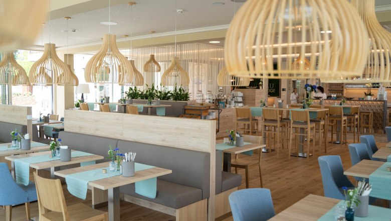 Modern café with wooden decor and blue accents.