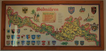 Map of South Moravia with coats of arms and illustrations in a wooden frame.