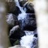 A waterfall flows over large rocks in the Ysperklamm gorge.