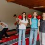 Children playing skittles in a hotel.