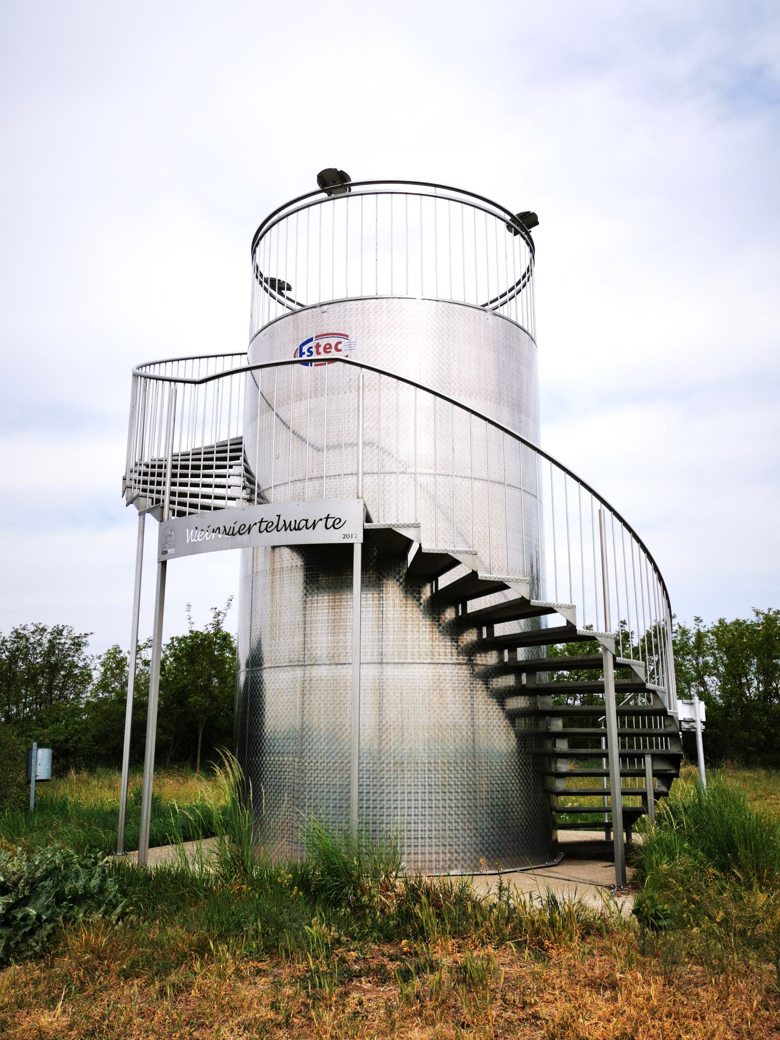Metal viewing platform with spiral staircase outside.