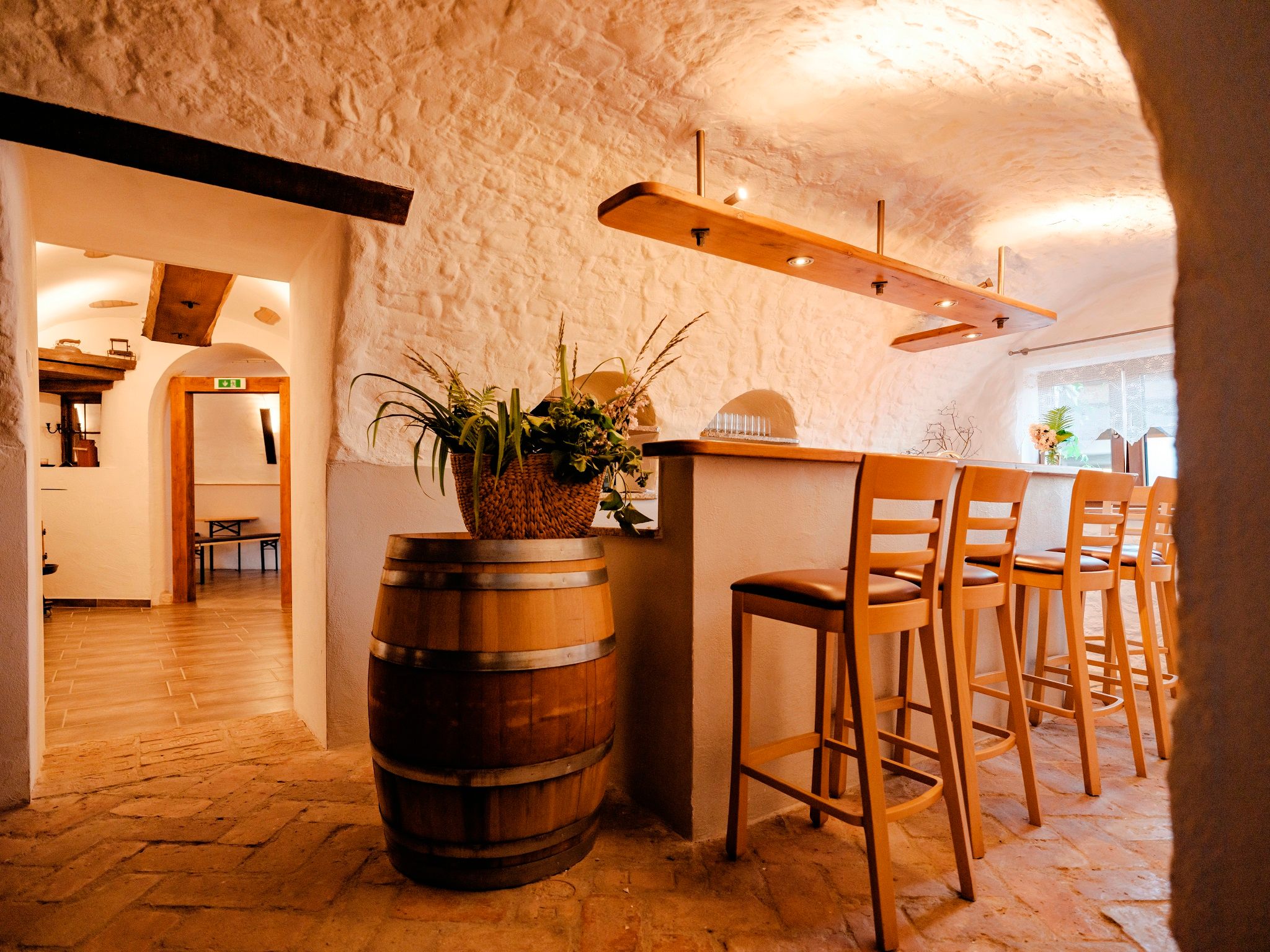 Cozy parlor with bar stools and rustic furnishings.