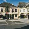 Historic buildings with stores and decorative facades on a sunny day.