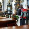 Two people with rucksacks in a richly decorated church.
