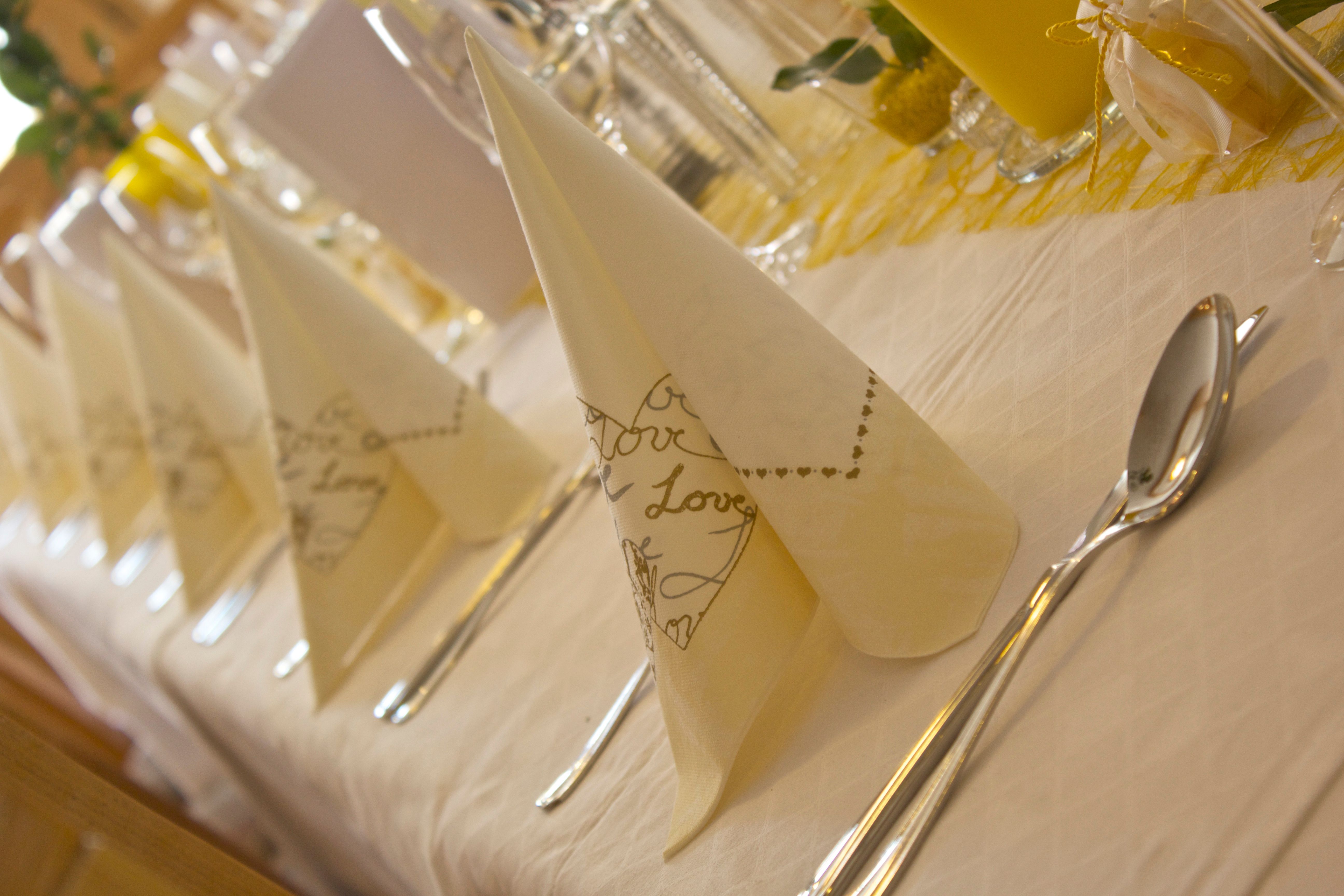 Elegantly laid table with folded napkins and cutlery.