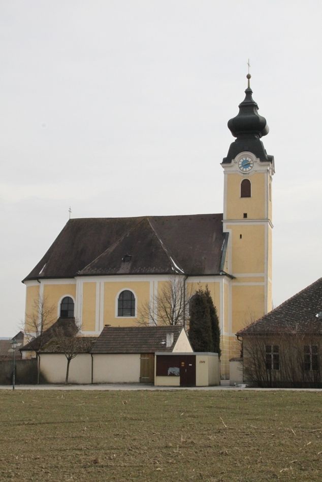 Langenrohr parish church with yellow façade and onion dome.