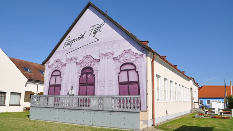 Leopold Figl Museum with painted façade and blue sky.