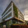 Modern hotel building with vertical garden wall and glass fa&ccedil;ade.
