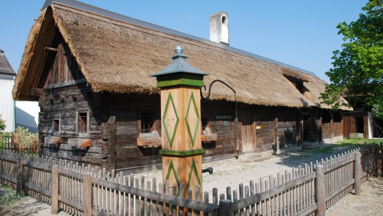 Traditional wooden house with thatched roof in the Haag open-air museum.