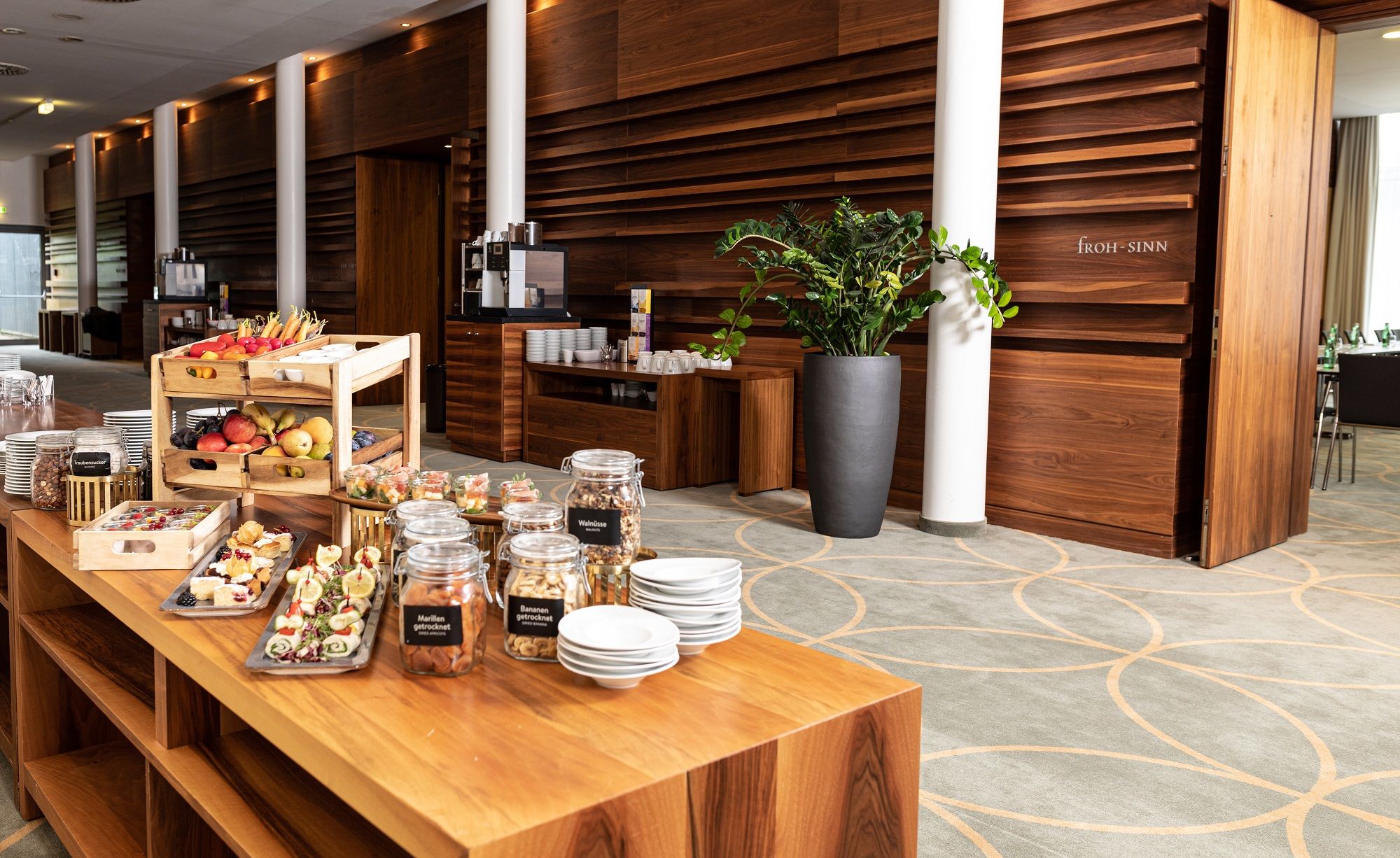 Buffet with snacks and drinks in a modern seminar room.