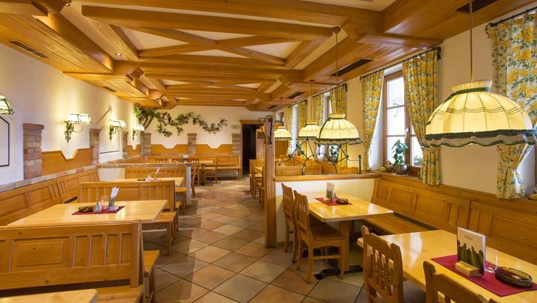 Interior view of a traditional wine tavern with wooden furniture and cozy lighting.
