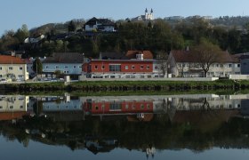 Town view of Marbach with buildings and church reflected in the water.