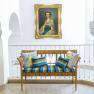 Elegant bench with colorful cushions in front of a painting in a bright room.