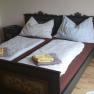 A traditionally decorated double bed with two bedside tables in a bedroom.