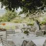 Garden with tables and chairs under a chestnut tree.