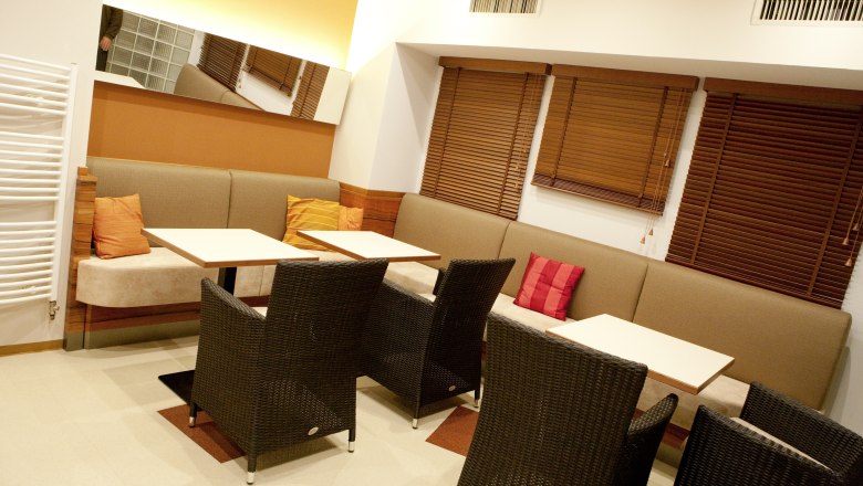 Cozy lounge area with sofas, tables and chairs.